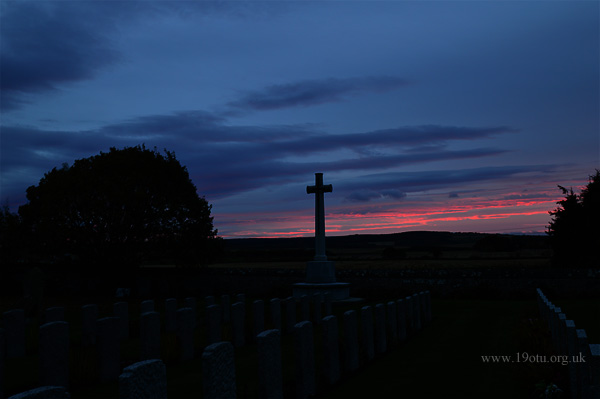 Sunrise at Kinloss Abbey, the Cross of Sacrifice and the Commonwealth War Graves.